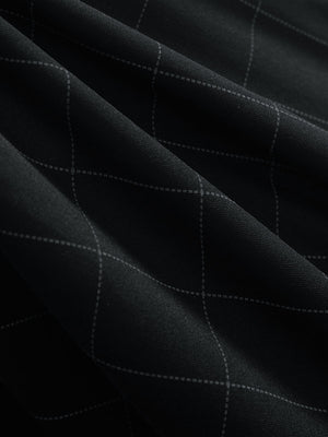 Close-up texture of rich black grid performance reflective checked collar golf shirt fabric showing weave detail.