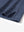 Detail shot of the hem vent on the blue quick dry jacquard ribbed collar golf shirt