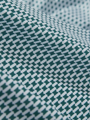 Close-up texture of dark green oval premium ribbed collar print polo shirts fabric showing detailed premium material and weave.