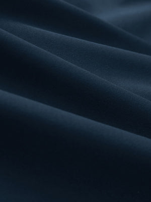 Close-up texture of navy women's 5 buttons collared polo shirts fabric showing detailed knit weave.