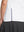 Detail view of hem design on white women's breathable 1/4 zip pullover golf shirts