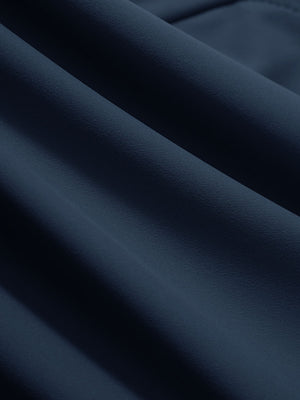 Close-up texture of navy women's high waist stretch golf pants with pockets fabric showing weave detail.