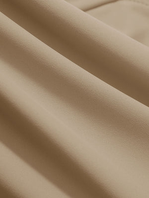 Close-up texture of light khaki women's high waist stretch golf pants with pockets fabric showing weave detail.