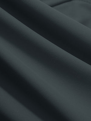 Close-up texture of dark grey women's high waist stretch golf pants with pockets fabric showing weave detail.