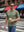 Front upper body angled shot of male model wearing green grey men's short sleeve slim fit Roma knit t-shirt while holding a coffee cup