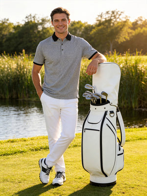 Full-body front view of model with a golf bag outdoors wearing the black  quick dry jacquard ribbed collar golf shirt