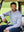 Model sitting on golf cart in white light blue grid ultra-light soft moisture wicking hoodies pullover