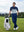 Model in blue indigo water resistant everyday pants standing with a golf bag outdoors, full-body shot